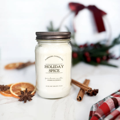 Mason Jar of 'Holiday Spice' candle with cinnamon sticks and dried oranges 